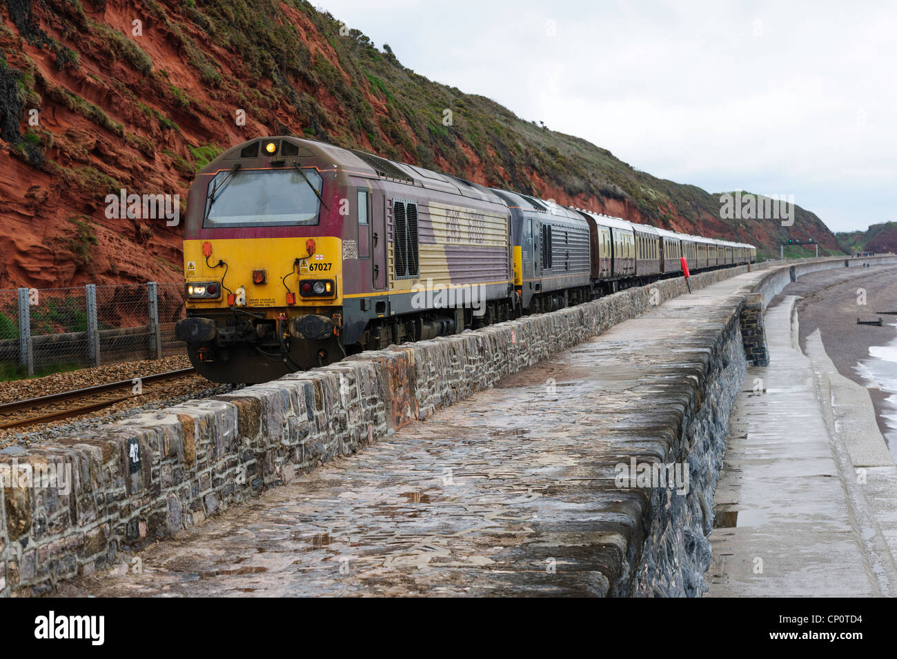 Diesel locomotives 67027 and 67005 double heading a rail tour along the sea wall Dawlish south Devon UK Stock Photo