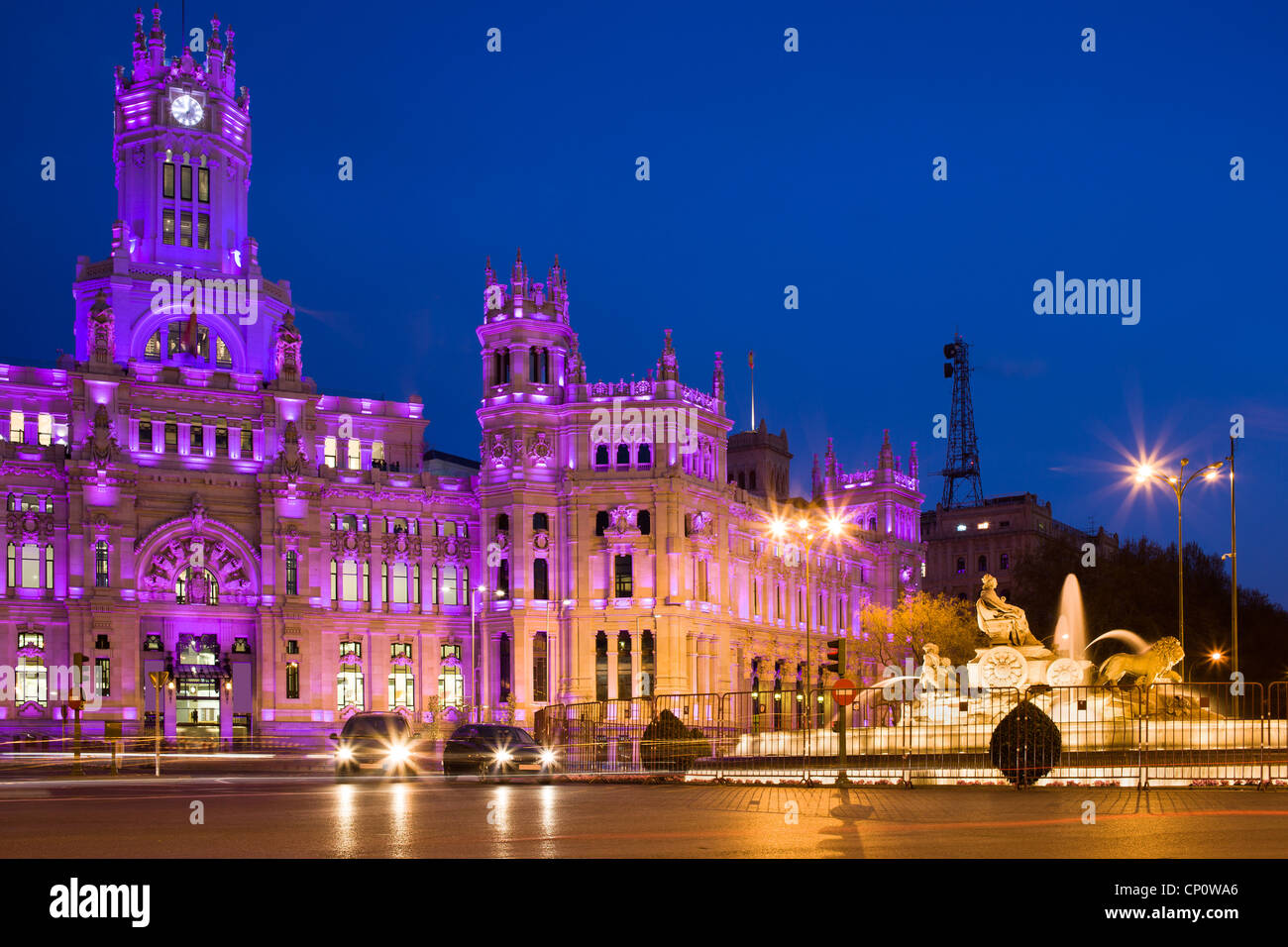 Palacio de Comunicaciones and the Cibeles Fountain on Plaza de Cibeles illuminated at night in the city of Madrid, Spain Stock Photo