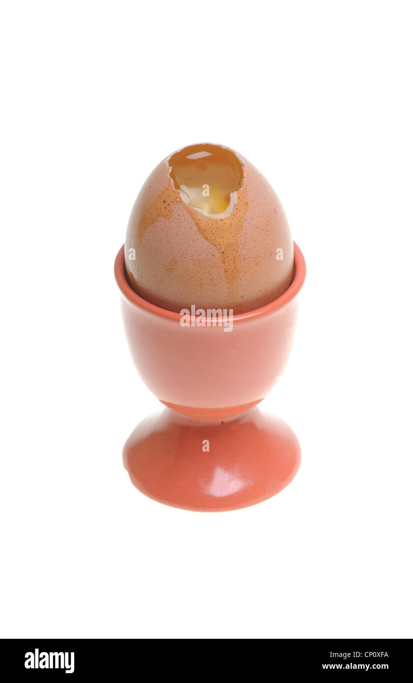 Signle egg with cracked shell in eggcup Stock Photo