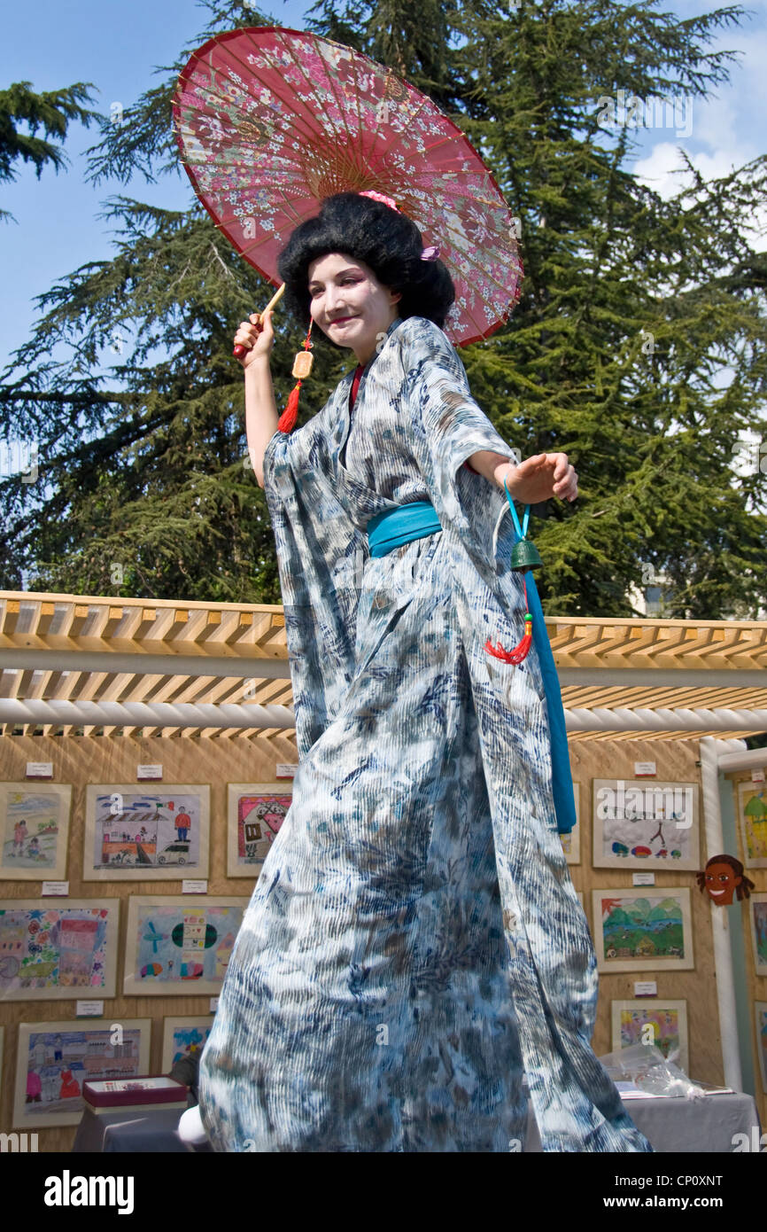 Japanese women on stilts during 'Le jardin japonais' (the japanese garden), an event at the Jardin d'acclimatation - Paris Stock Photo