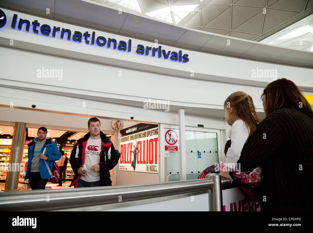 A family at the International Arrivals department, Stansted Airport Essex UK Stock Photo