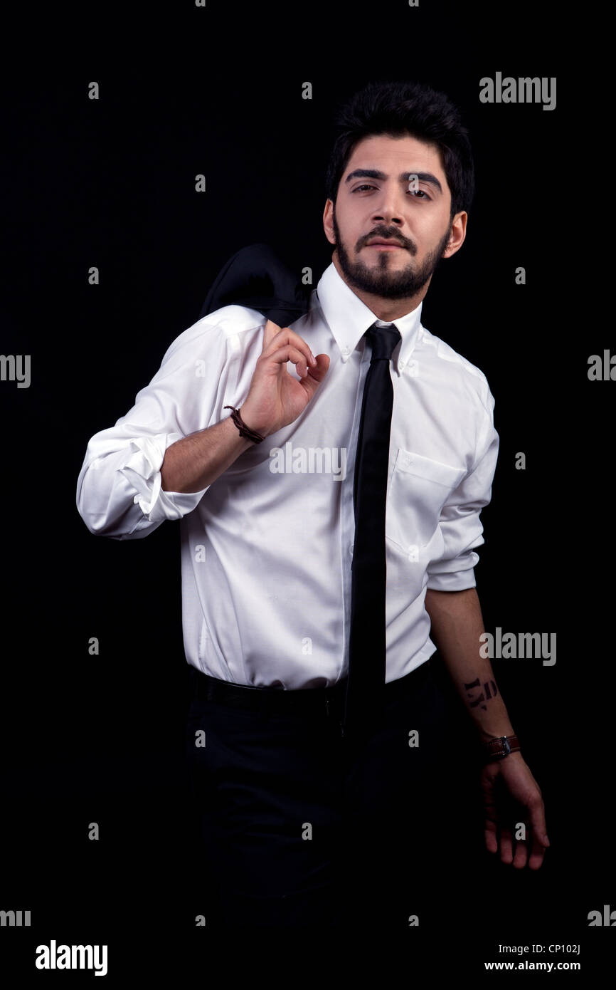 young successful business man with a suit isolated on black background ...