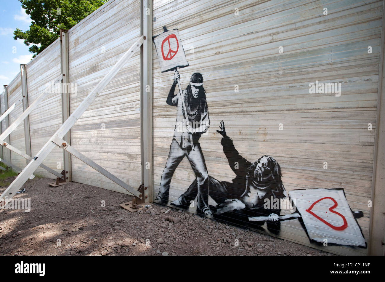 Original Banksy piece on the 'Super Fence' surrounding the Glastonbury Festival site. Stock Photo