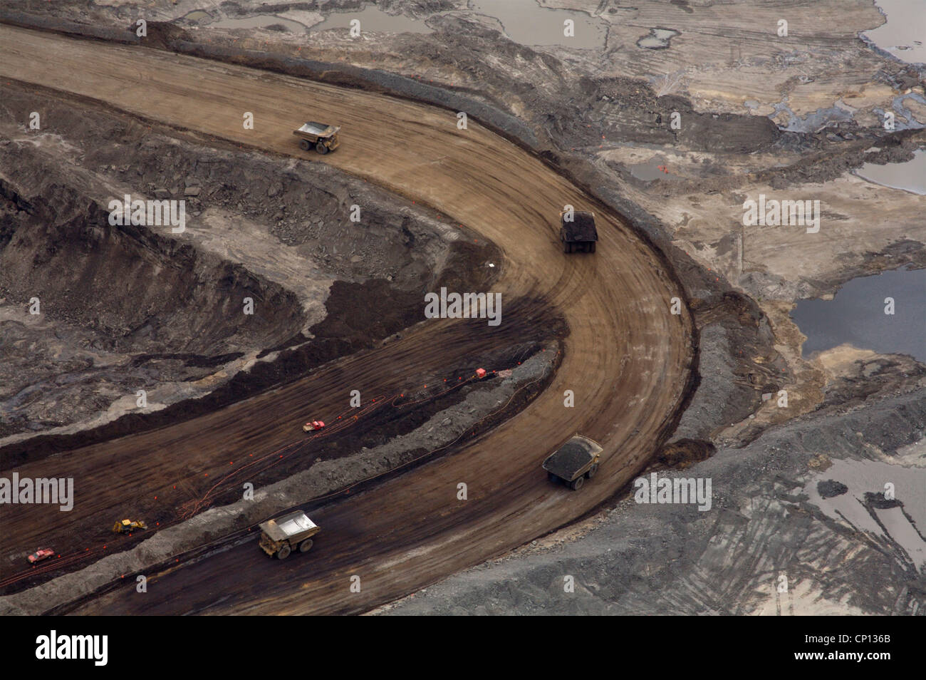 Tar sands mine, Alberta, Canada showing huge trucks used to carry the oil-rich sands. Aerial view Stock Photo
