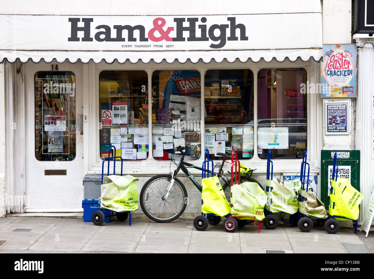 Newspaper delivery bags outside Village Newsagents shop, Heath Street, Hampstead, London, England, UK Stock Photo