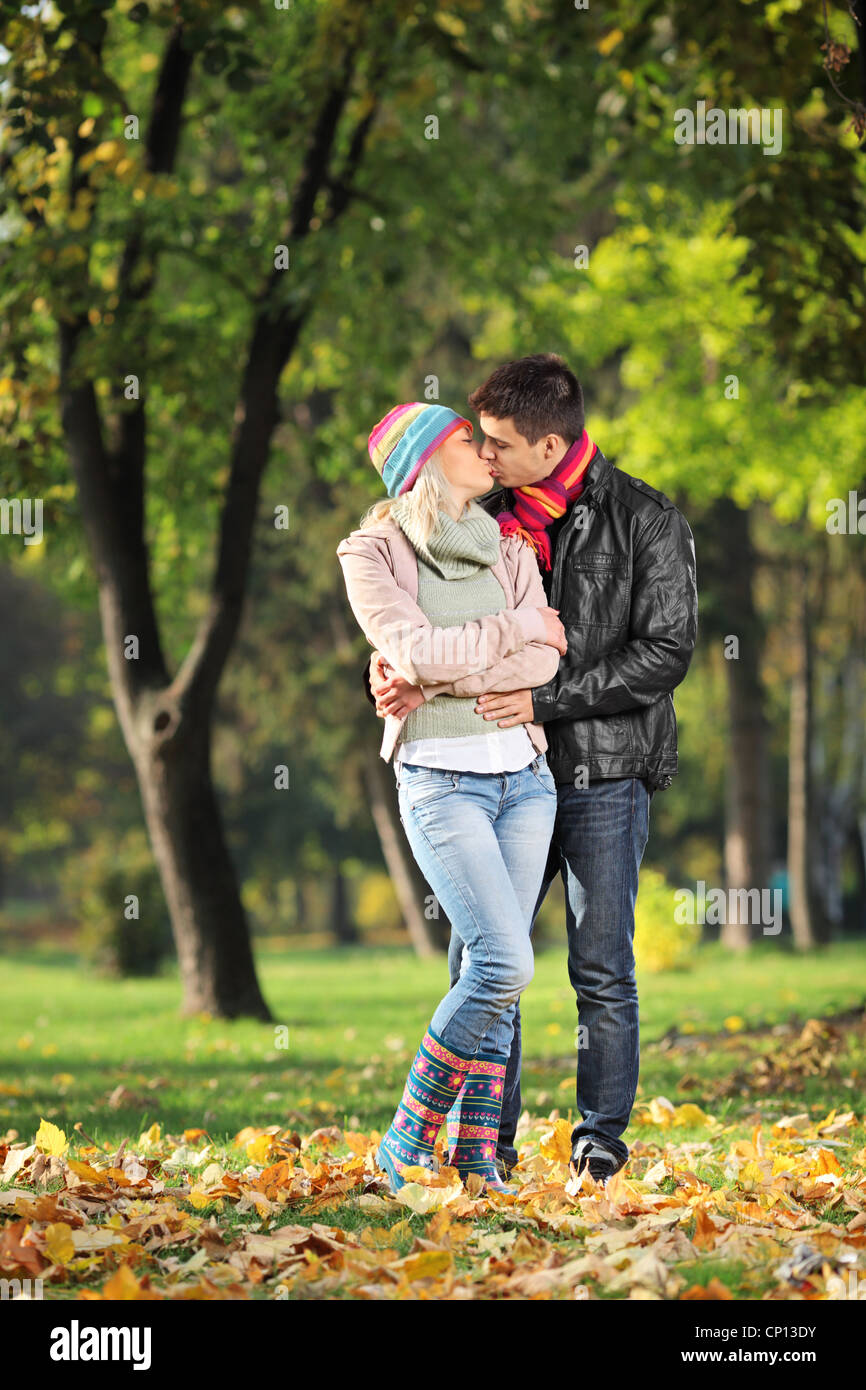 A loving couple kissing in the park in autumn Stock Photo - Alamy