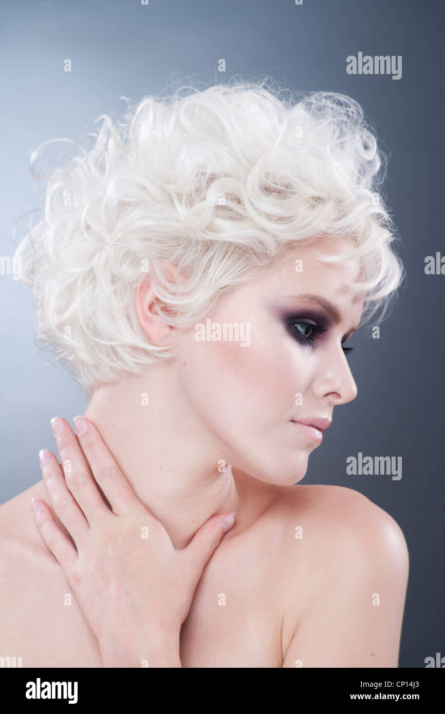 white haired woman studio shot hair dressing with bokeh effect Stock Photo