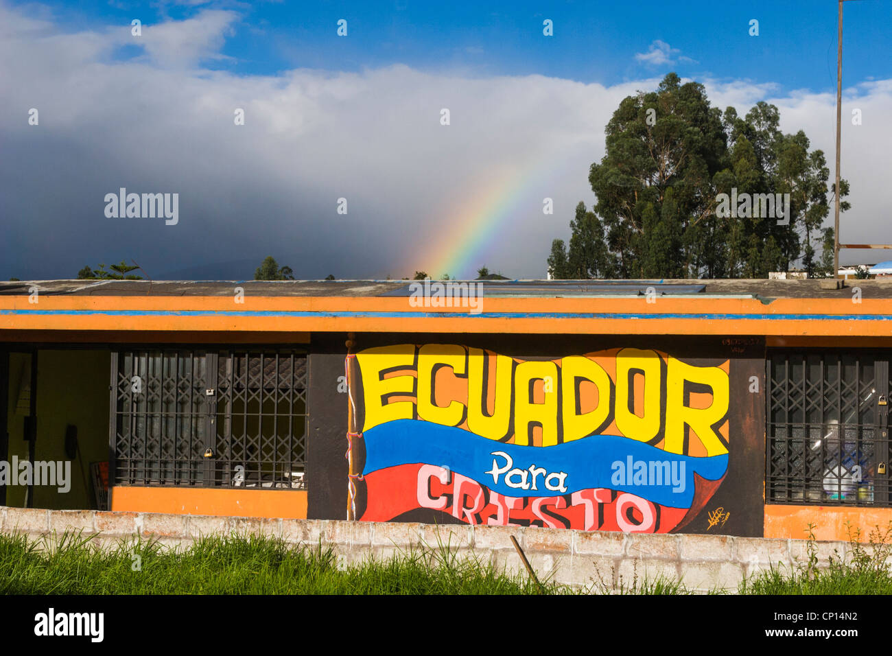 Rainbow over sign on building in Quito, Ecuador. Stock Photo