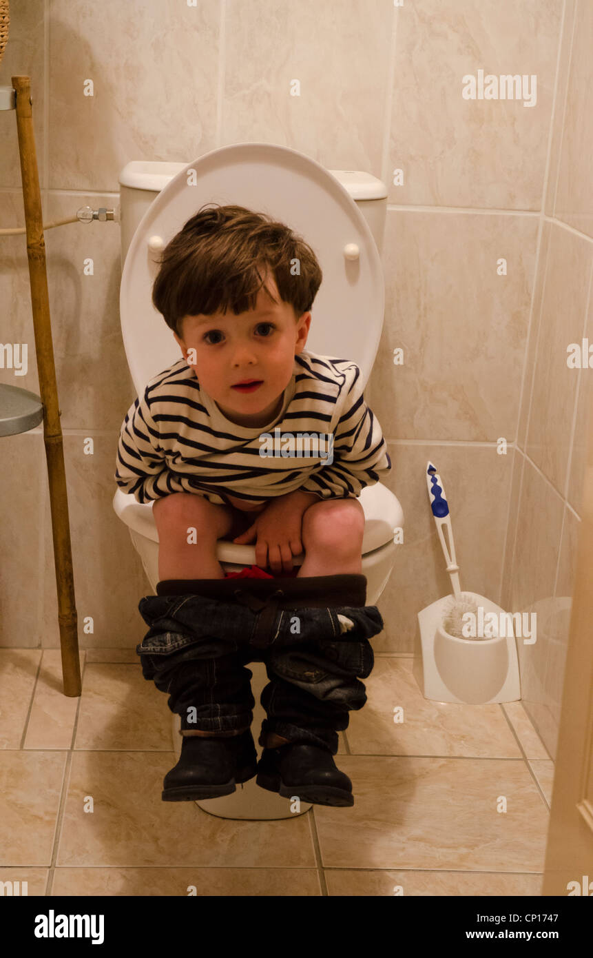 Little white boy sitting on the toilet Stock Photo