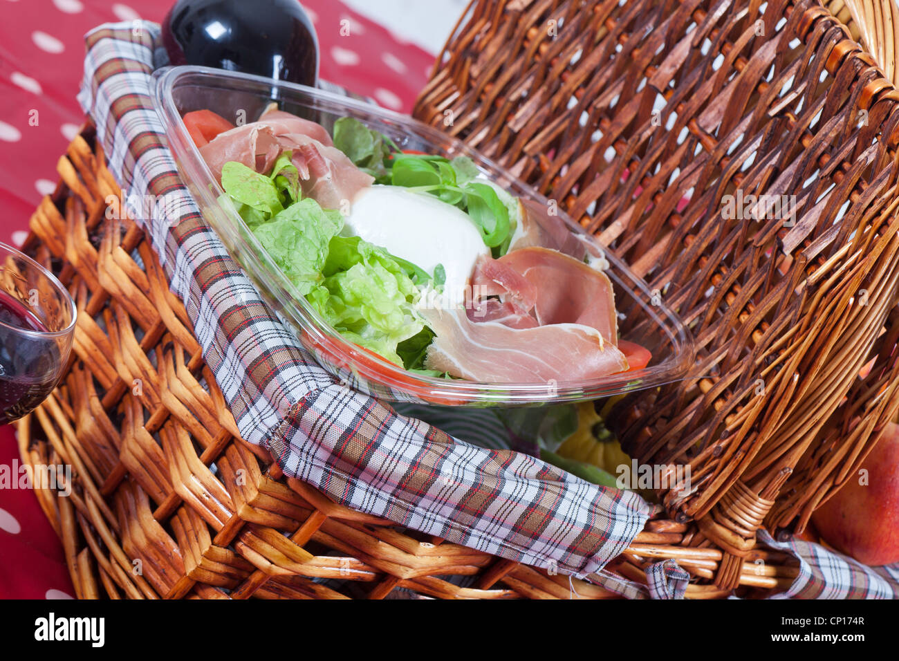 Picnic basket with salad and fruits Stock Photo Alamy