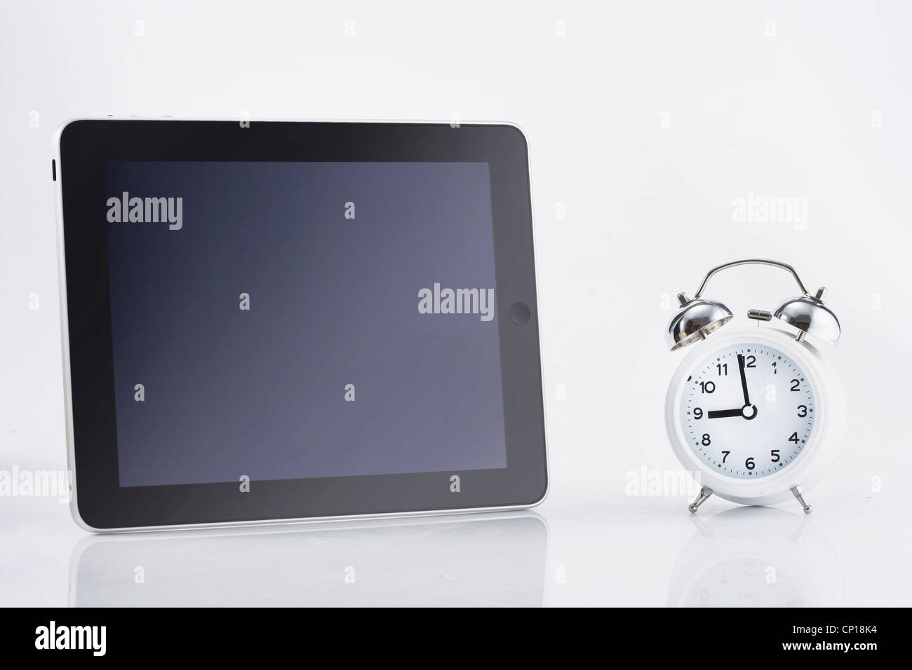 A tablet PC and an alarm Stock Photo Alamy