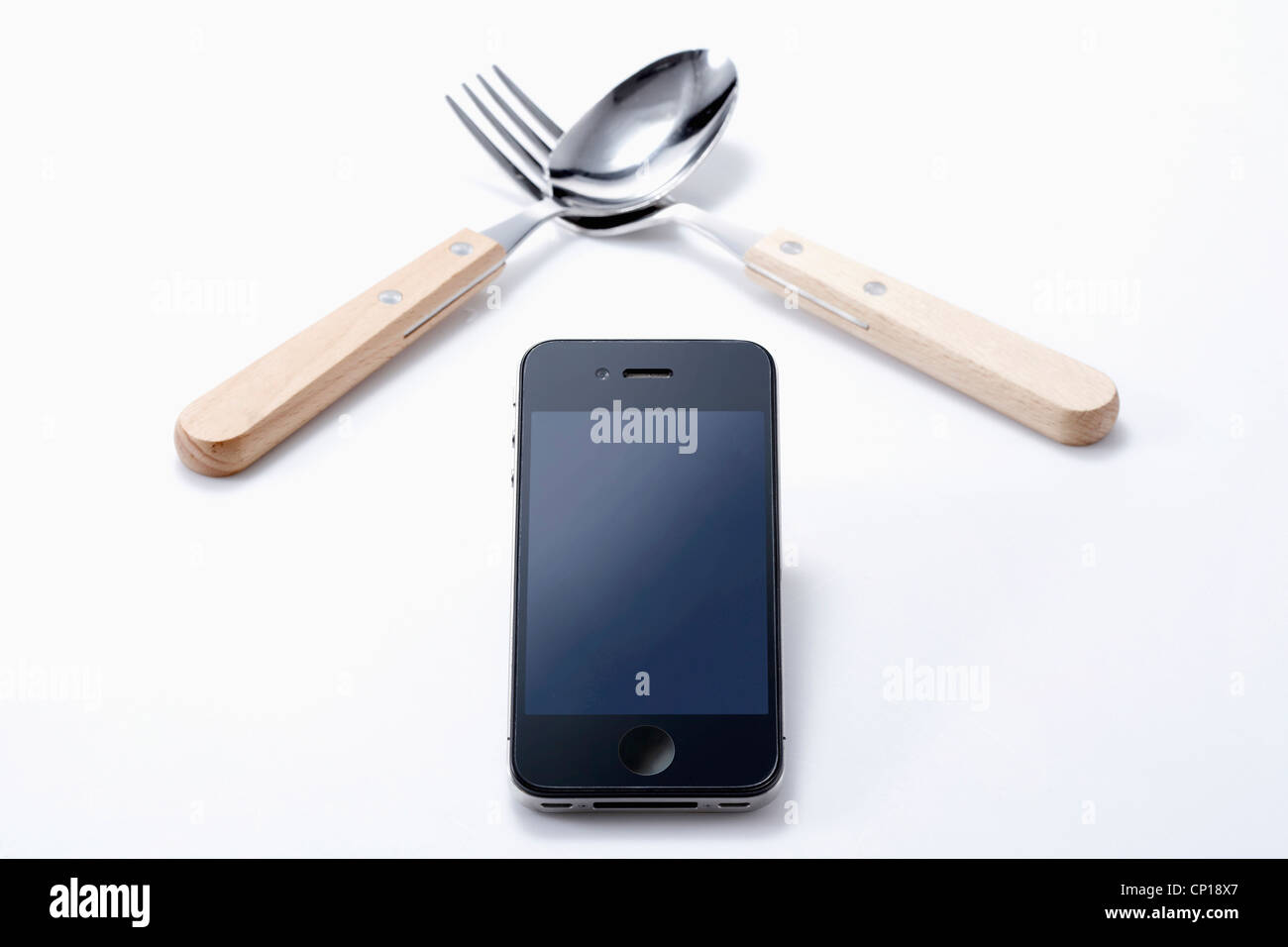 A smart phone, spoon, and fork Stock Photo Alamy