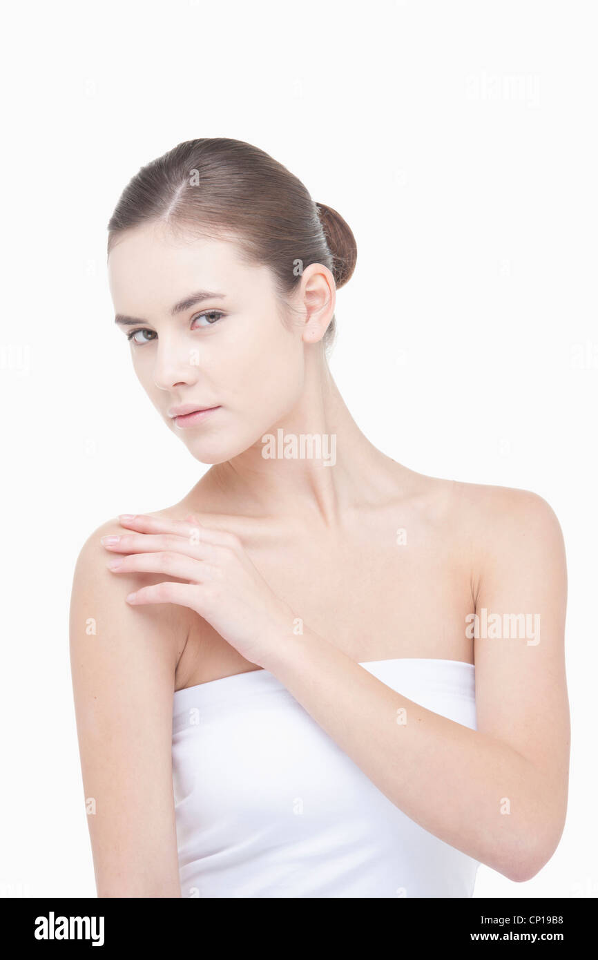 A woman touching her shoulder Stock Photo - Alamy
