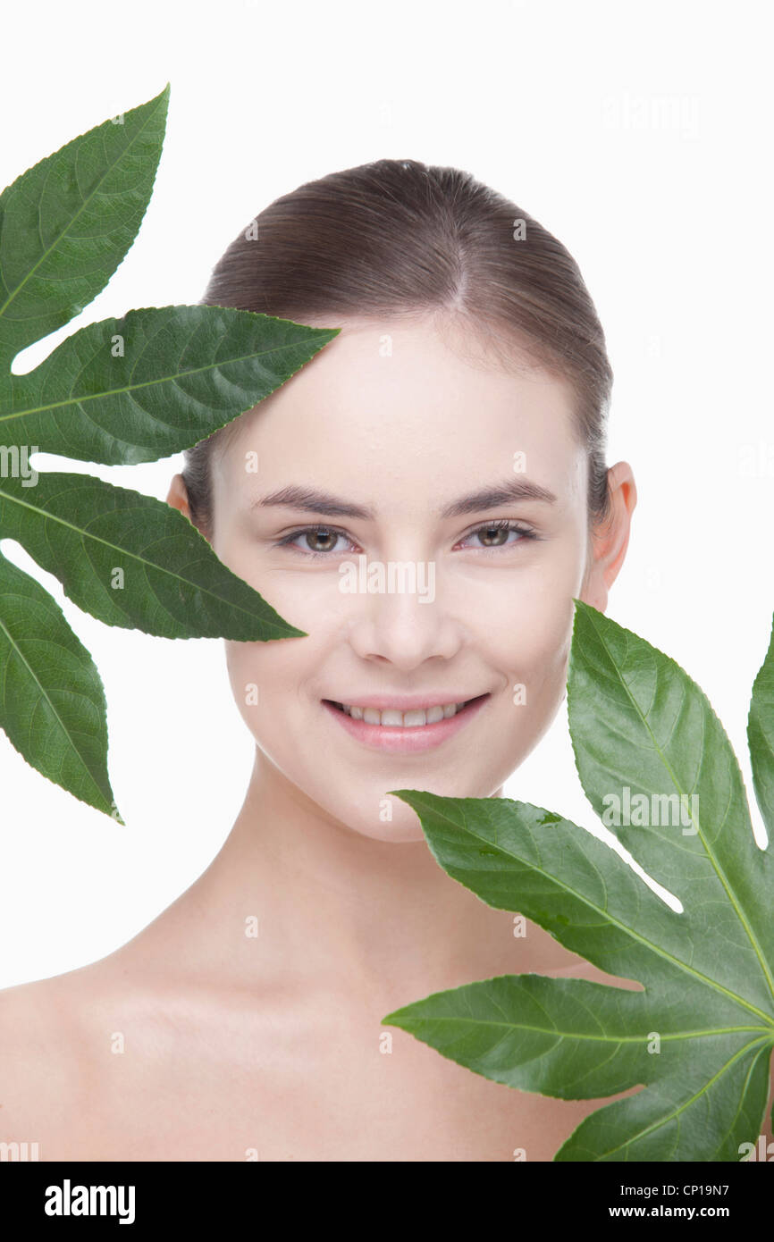 A woman with green leaves Stock Photo - Alamy