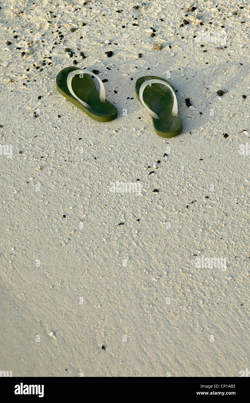 Maldives Leisure. beach shoes in the sand Stock Photo Alamy