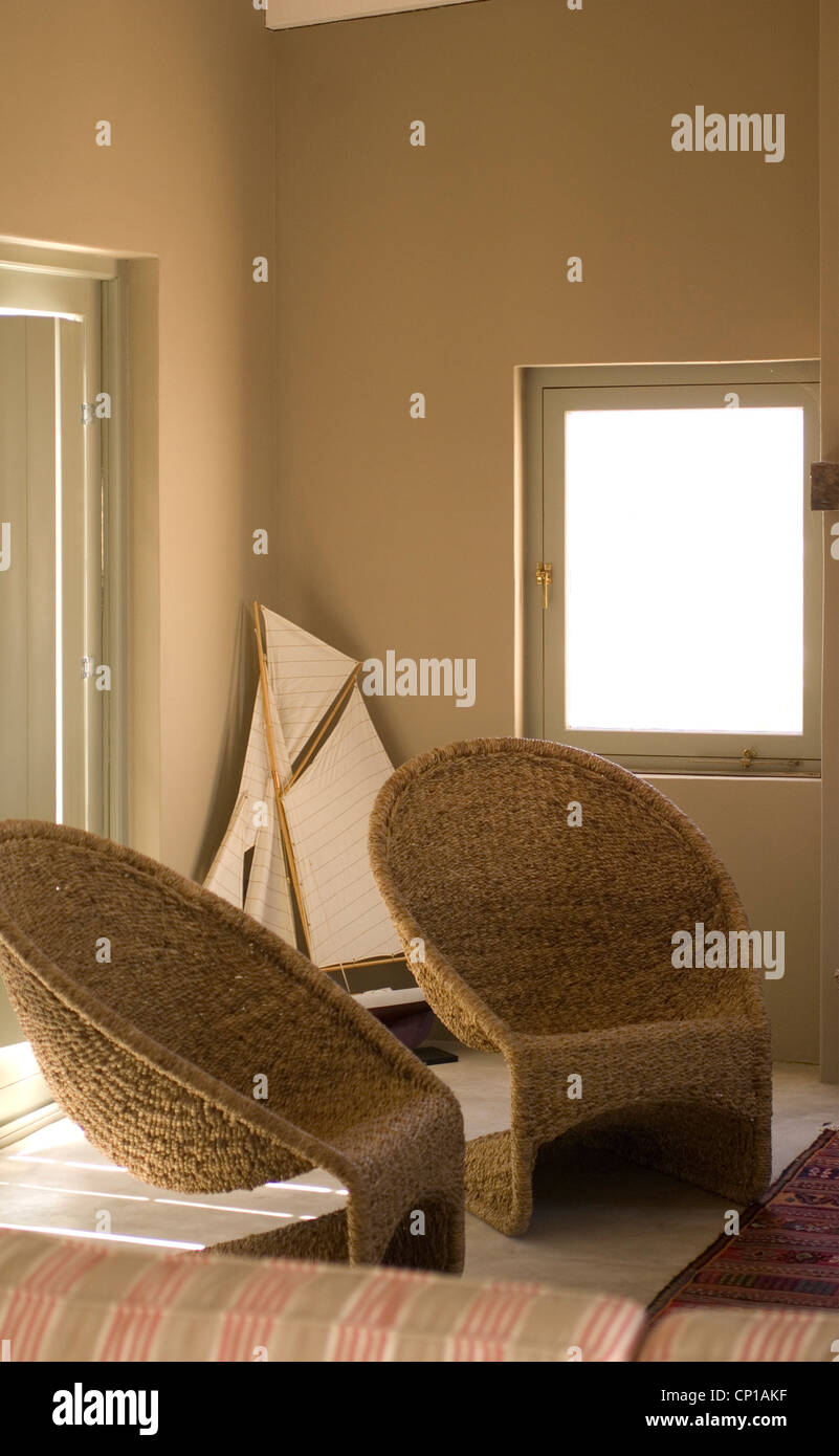 Two wicker armchairs in a beach house Stock Photo Alamy