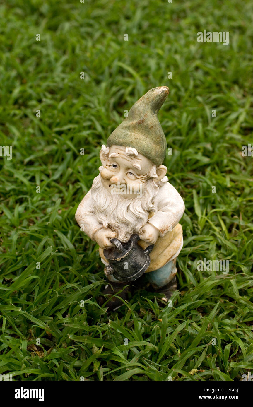 Garden gnome holding watering can. Stock Photo