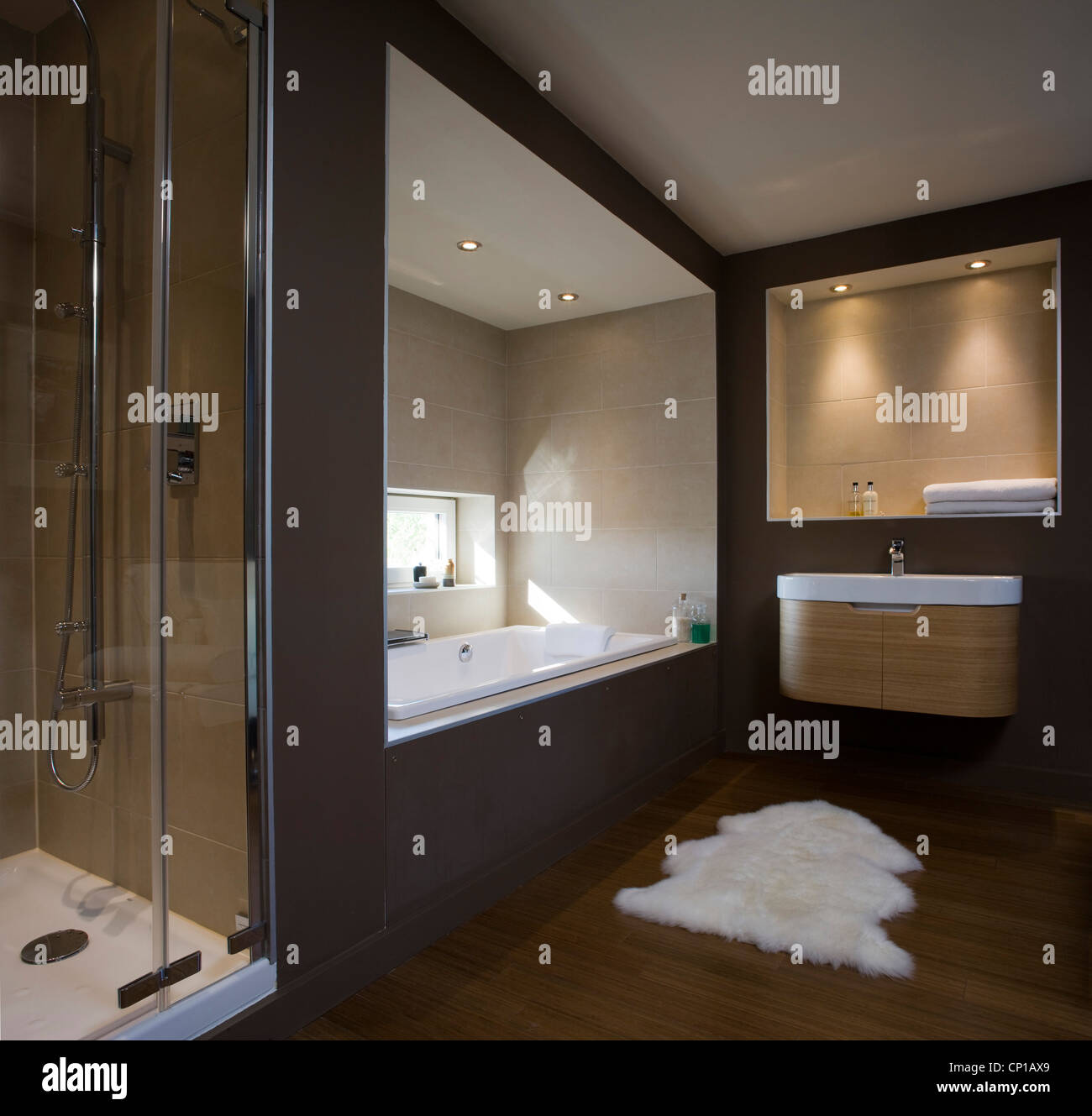 Dark brown bathroom with recessed bathtub in carbon neutral home in