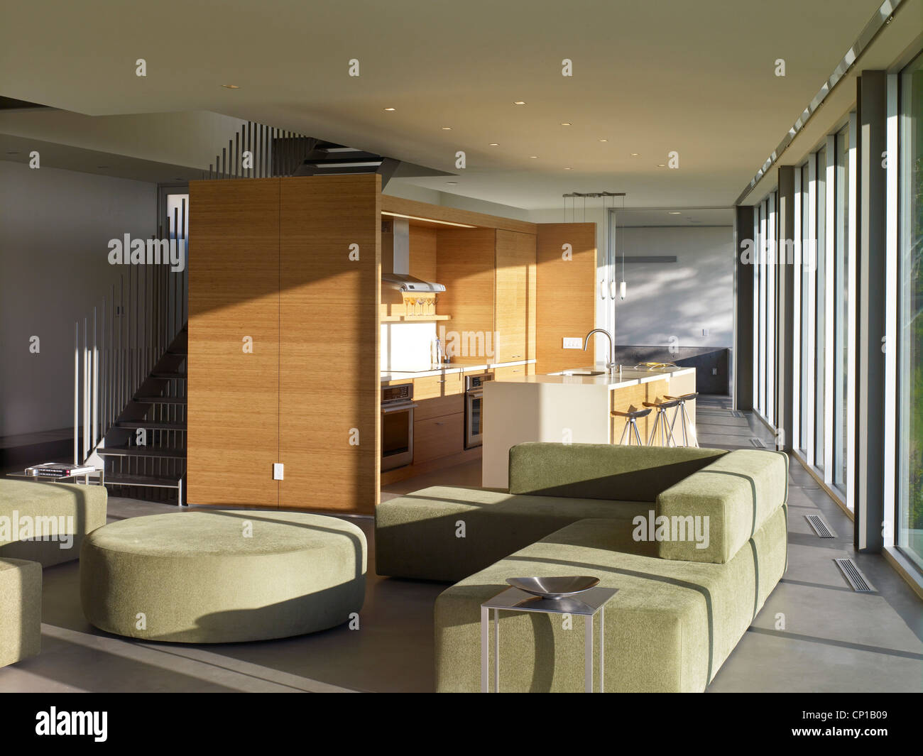 Green seating area and freestanding kitchen in open plan Briarcrest