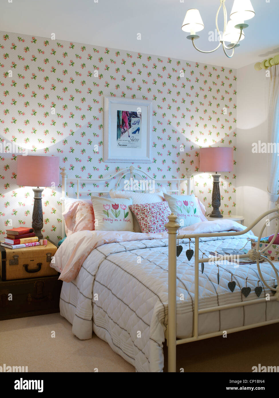 Matching lamps at bedside in showhome of new housing development in