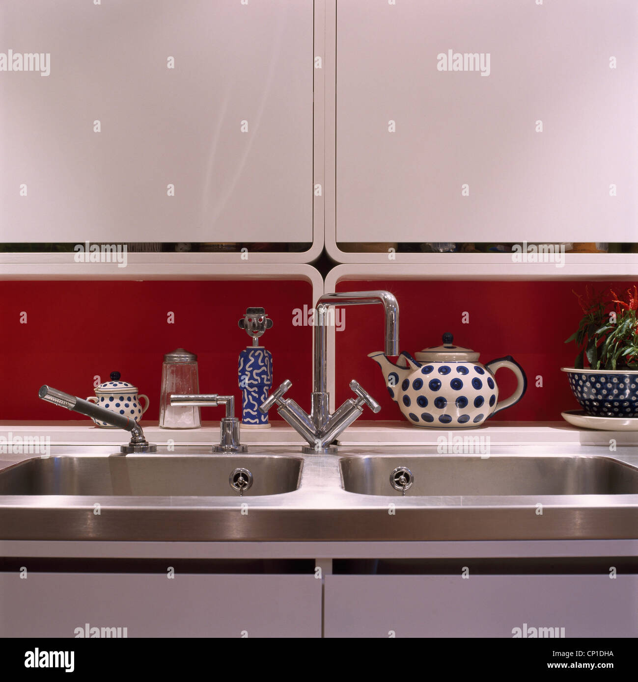 Stainless steel double sink with cupboards above Stock Photo Alamy