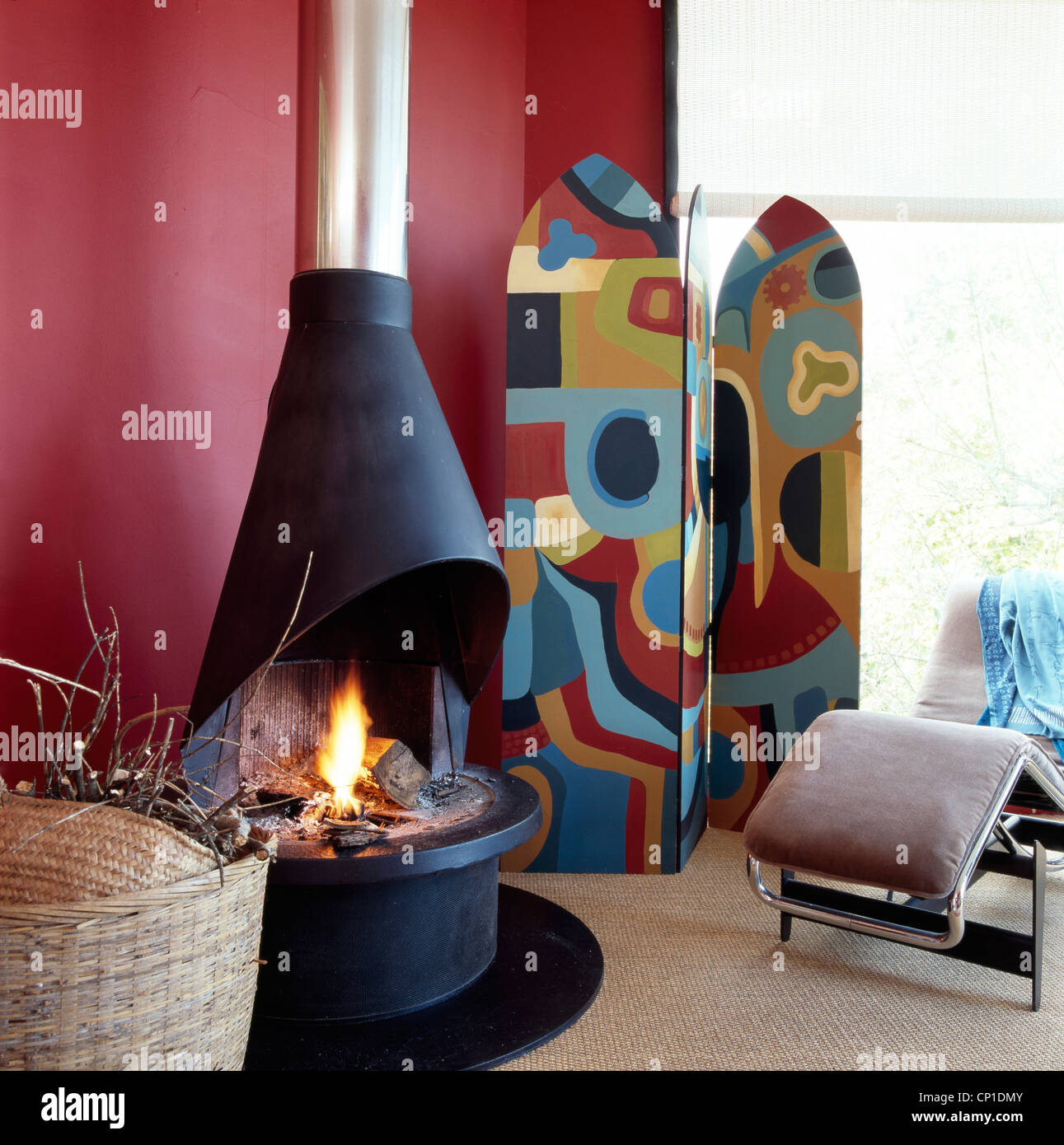 Folding screen next to contemporary wood burning stove with chimney Stock Photo Alamy