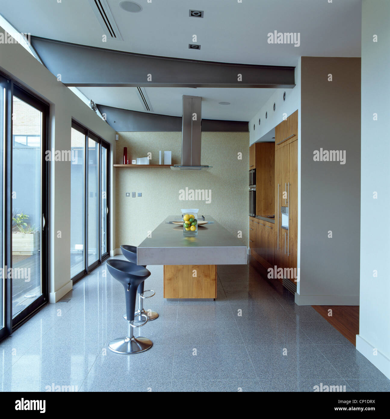 Bar stools at central island unit in modern kitchen Stock Photo Alamy