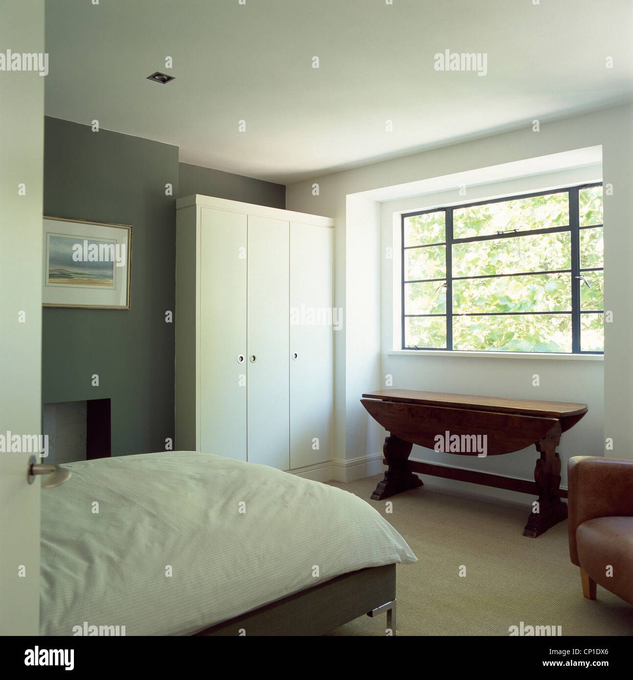 A Modern Bedroom Double Bed Wooden Table Below Window Fitted