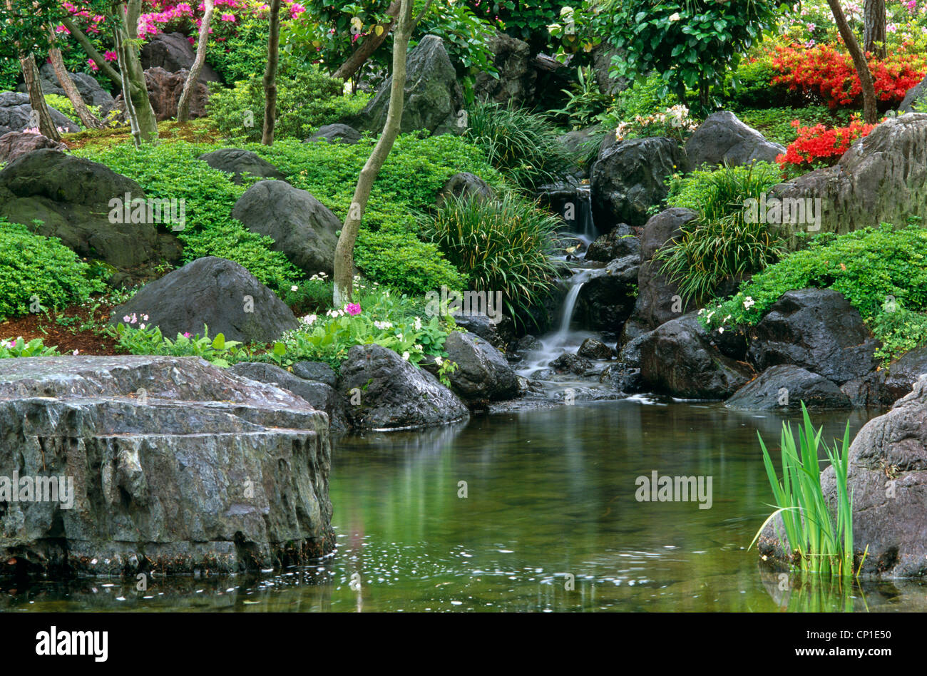 Rocky waterfall and pond in garden Stock Photo - Alamy
