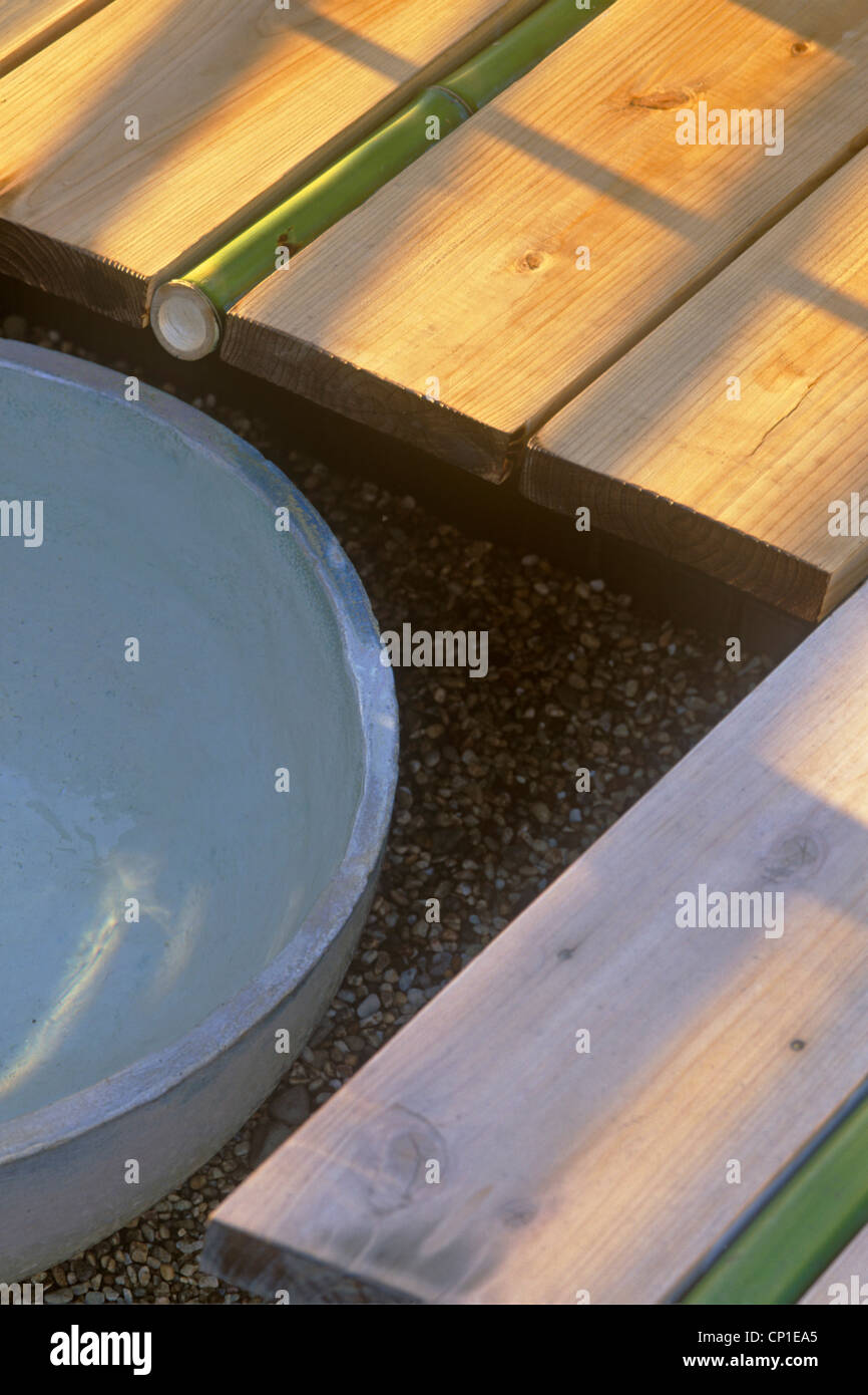 Close up of Japanese style water feature with bamboo pipe set in