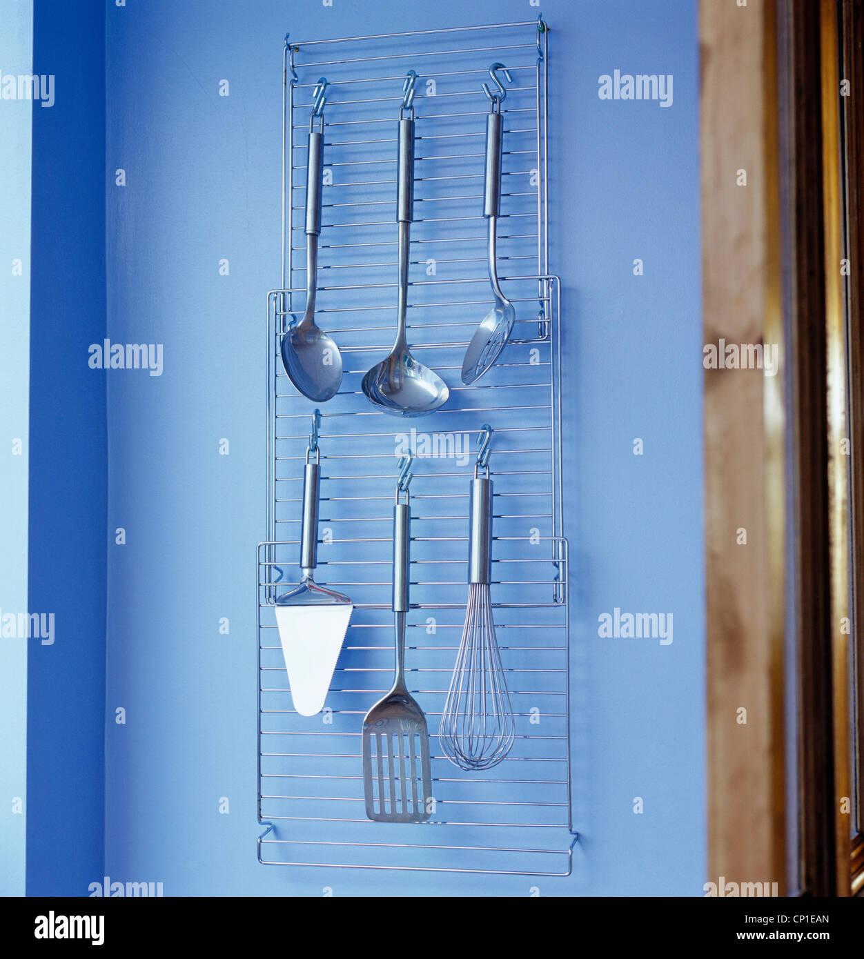 Stainless steel kitchen utensils on hanging wire rack Stock Photo Alamy