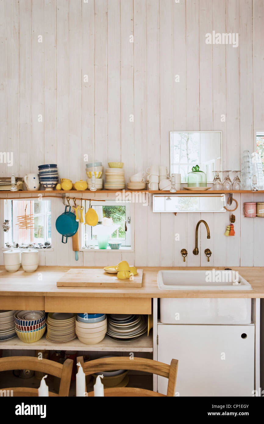 Kitchenware On Shelf Above Sink Set In Wooden Worktop In Country Style Kitchen With Wooden Walls Stock Photo Alamy