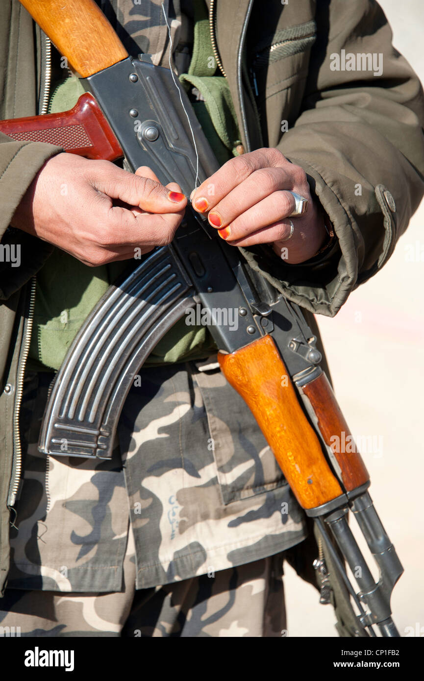 Painted nails on Afghan soldier with an AK47 Stock Photo