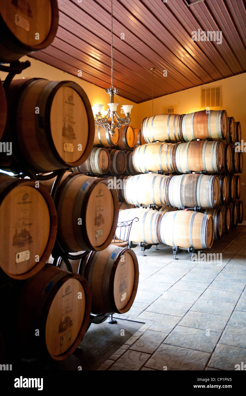 Barrels of wine stacked in the cellar of a winery Stock Photo - Alamy