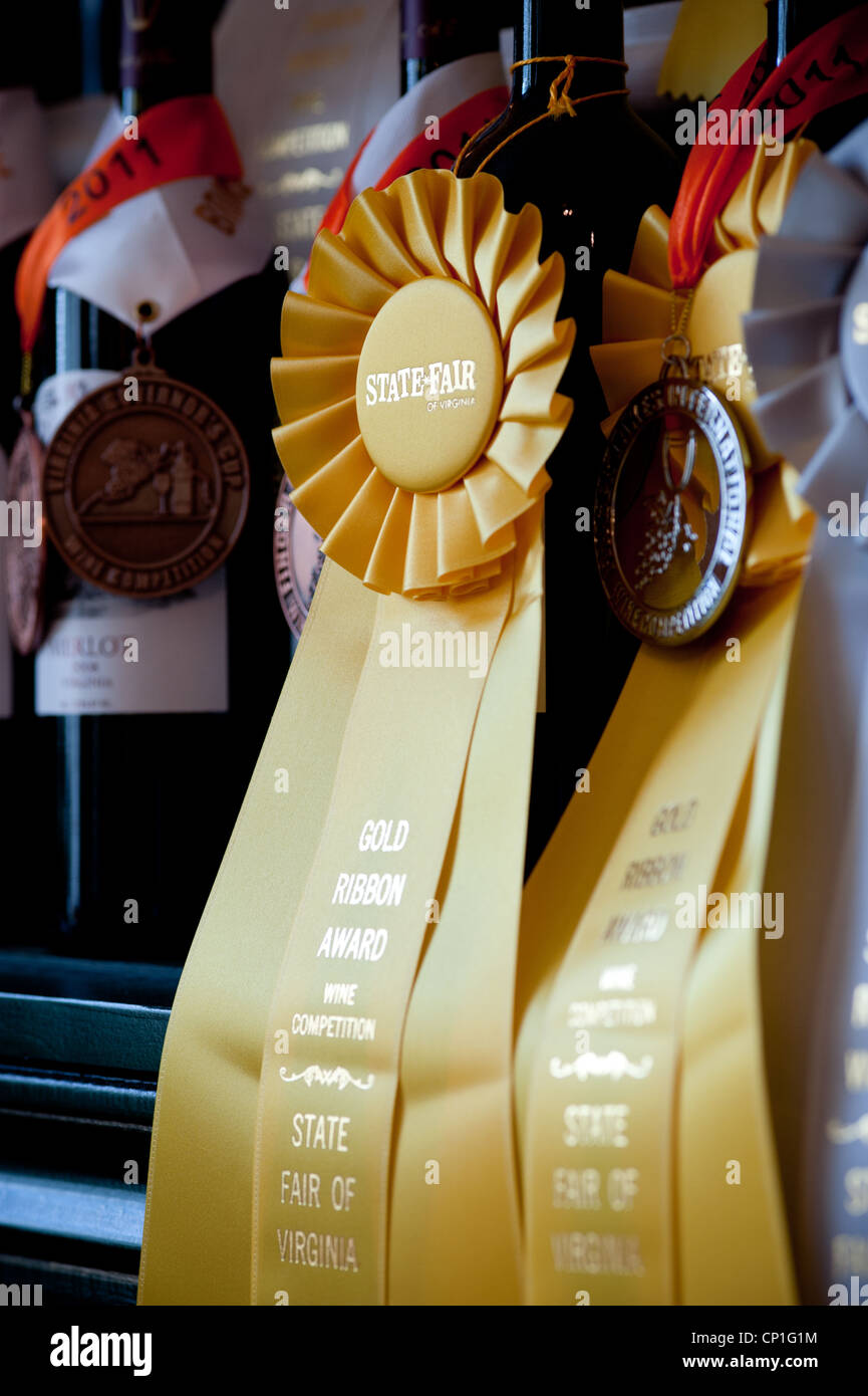 Shelves of award winning wine bottles with prize ribbons Stock Photo