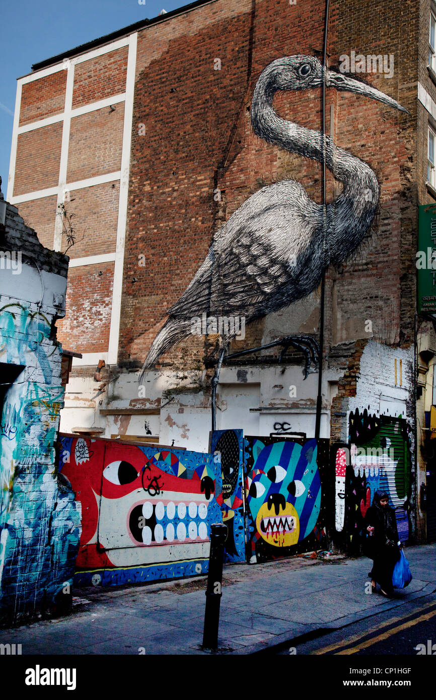 Street Art in East London. Roa is a Belgian street artist renowned for his giant black and white animals. Crane on Hanbury St. Stock Photo