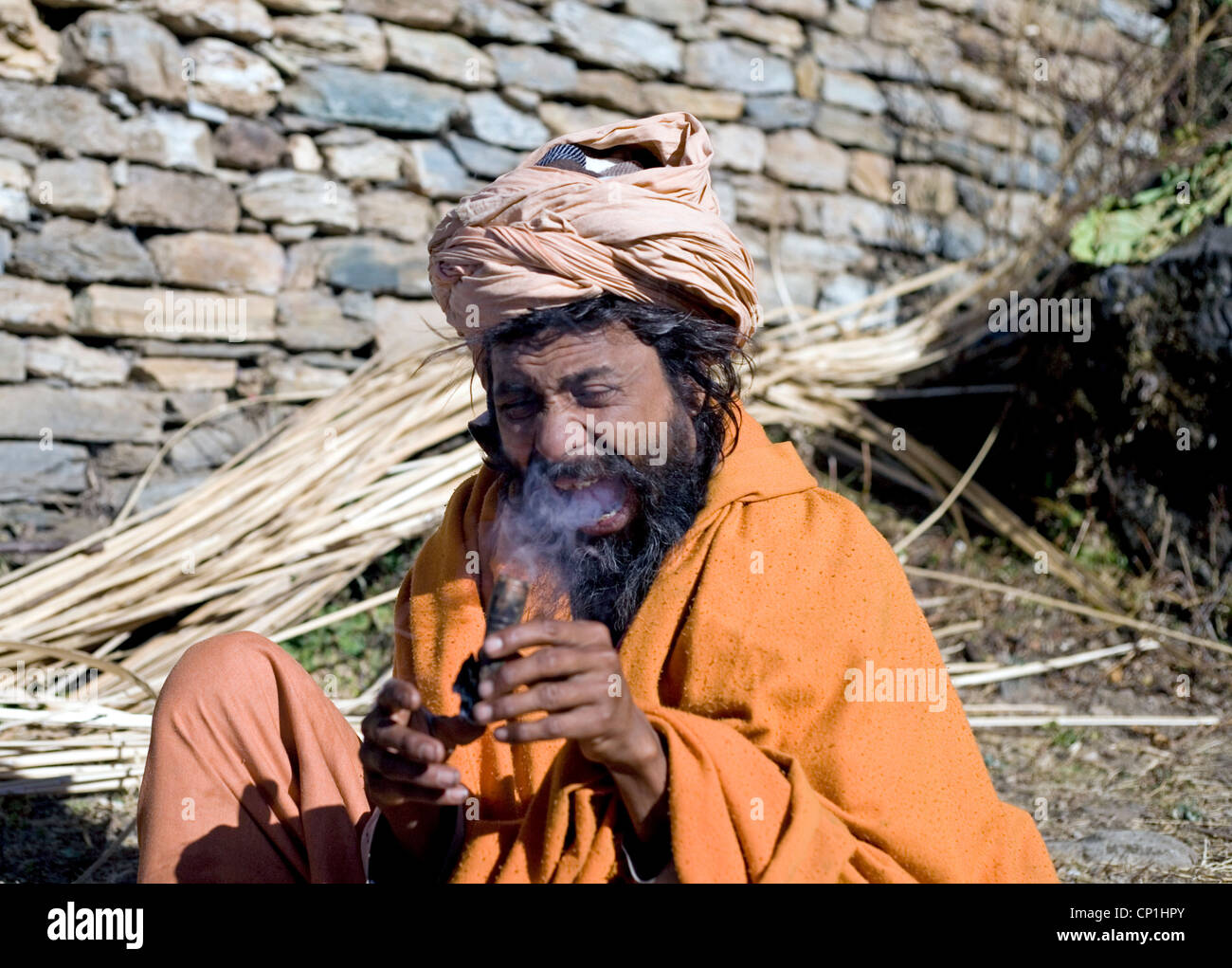 Sadhu smoking chilum , Balkara on the way to holy Muktinath  ,Nepal Stock Photo