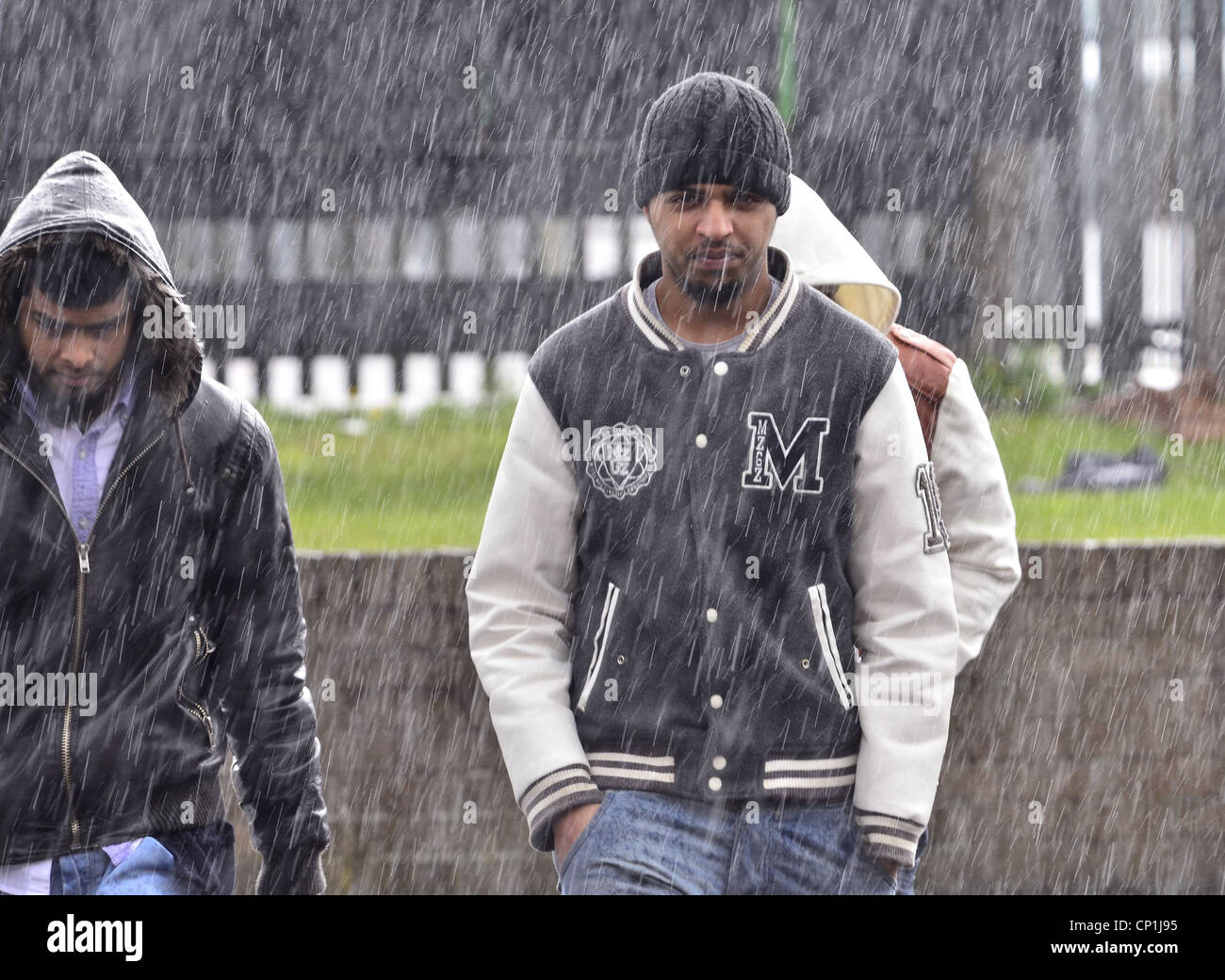Young Muslim men in the rain Stock Photo