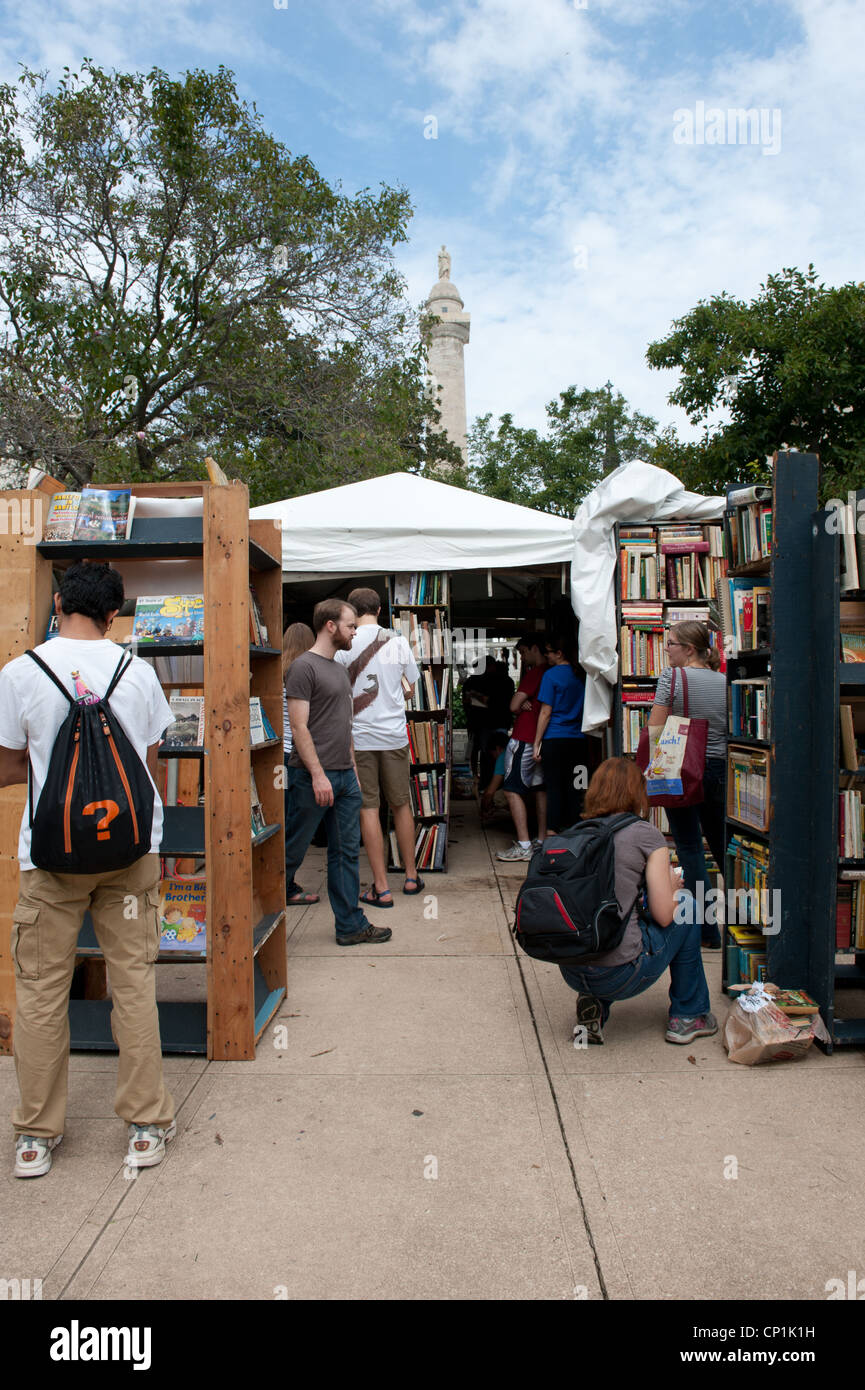 People shopping for books on shelves at Baltimore Book Festival Stock Photo