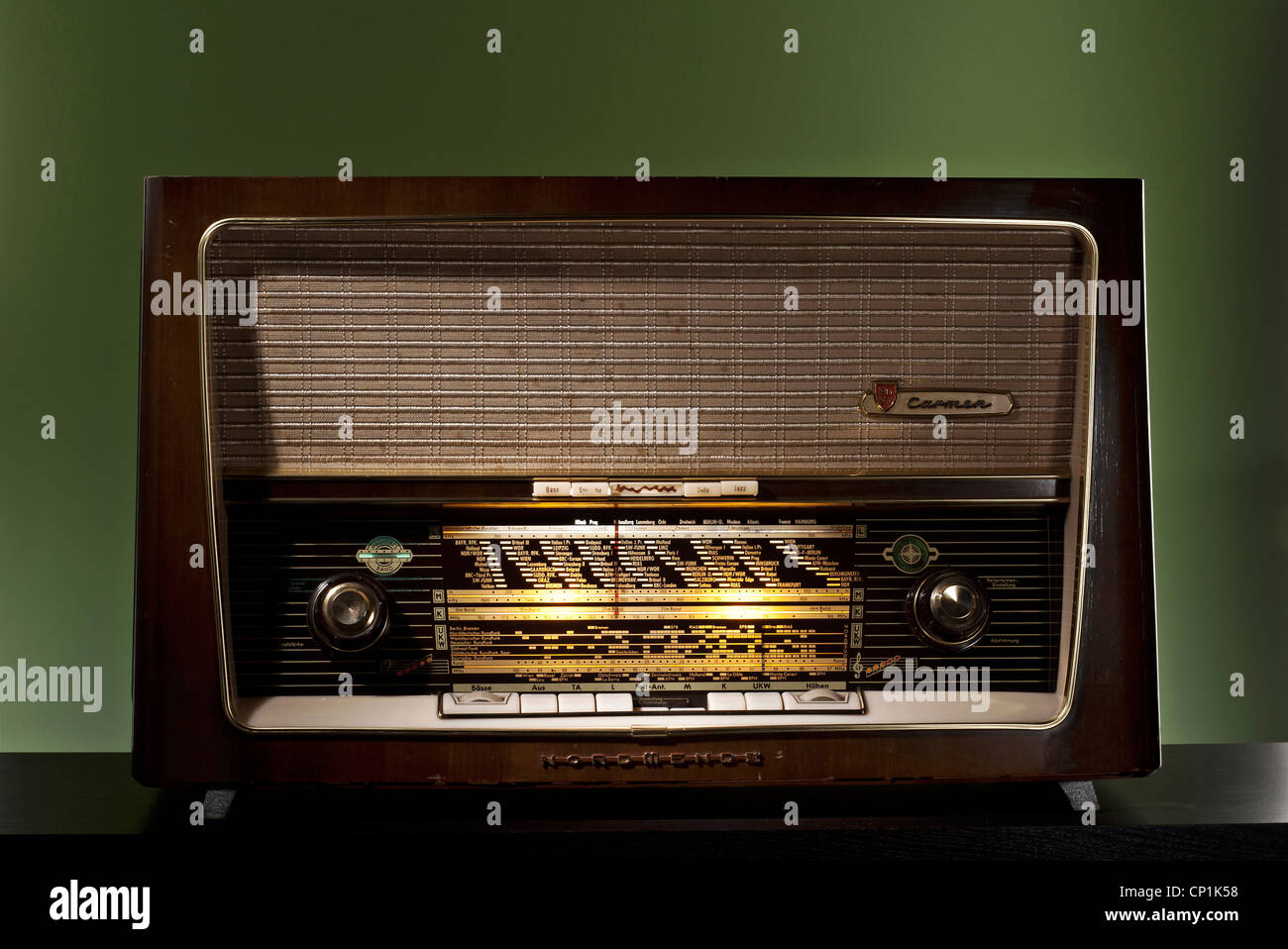 Old tube radio on a green background. Stock Photo