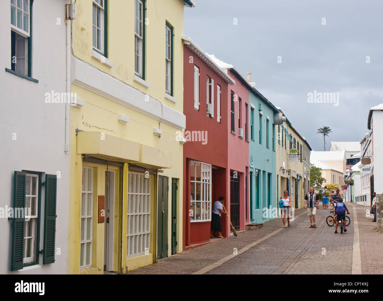 Tourists walking down alley on Bermuda waterfront Stock Photo