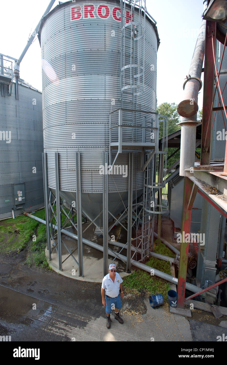 Farmer standing in front of grain bins on farm Stock Photo Alamy