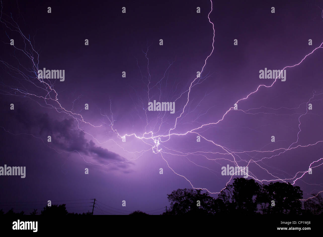 Lightning bolts illuminate the stormy night sky during a Midwestern storm over Central Indiana Stock Photo