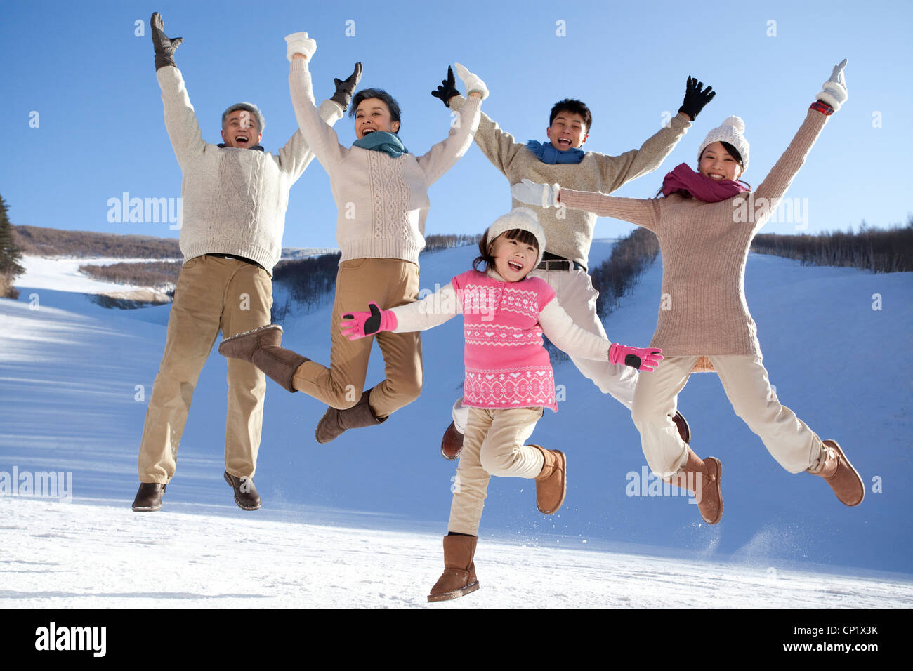 Family having fun in snow Stock Photo - Alamy