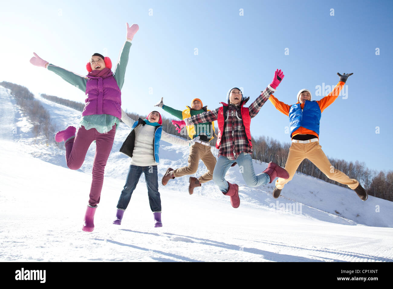 Young people having fun in snow Stock Photo - Alamy