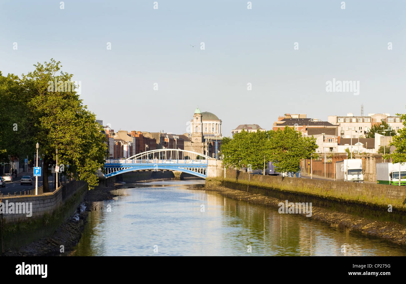 Dublin city at sunset - view over the Rory O'More and James Joyce's bridges and the Four Courts. On the Liffey river. Stock Photo