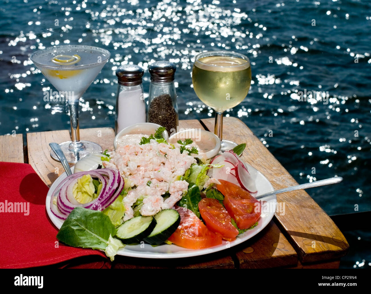 A Lovely Shrimp Louie Salad with a Martini and Wine at an Oceanside Restaurant on a Sparkling Summer Day Stock Photo