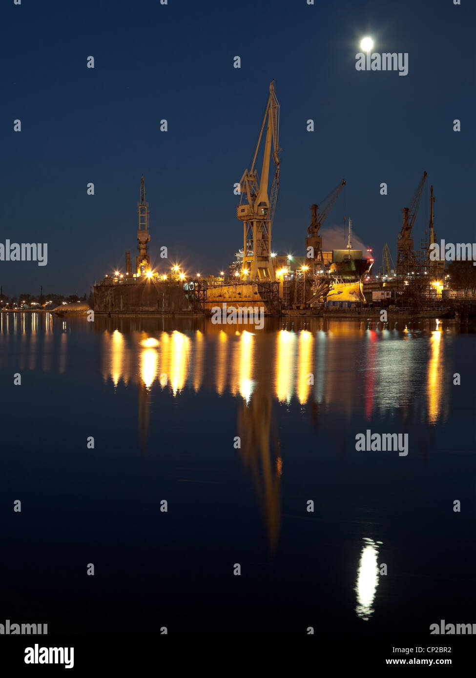 Dry dock in the moonlight at the shipyard in Gdansk, Poland. Stock Photo