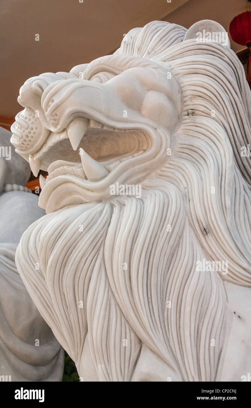 Stone carving of a growling male lion, Danang, Vietnam Stock Photo