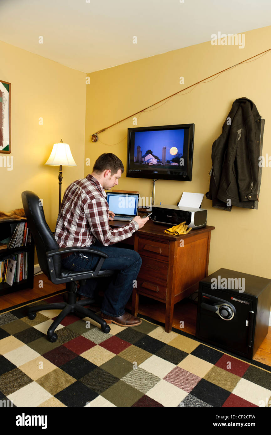 FARMER IN HOME OFFICE USING LAPTOP COMPUTER; WORKING FROM HOME Stock ...